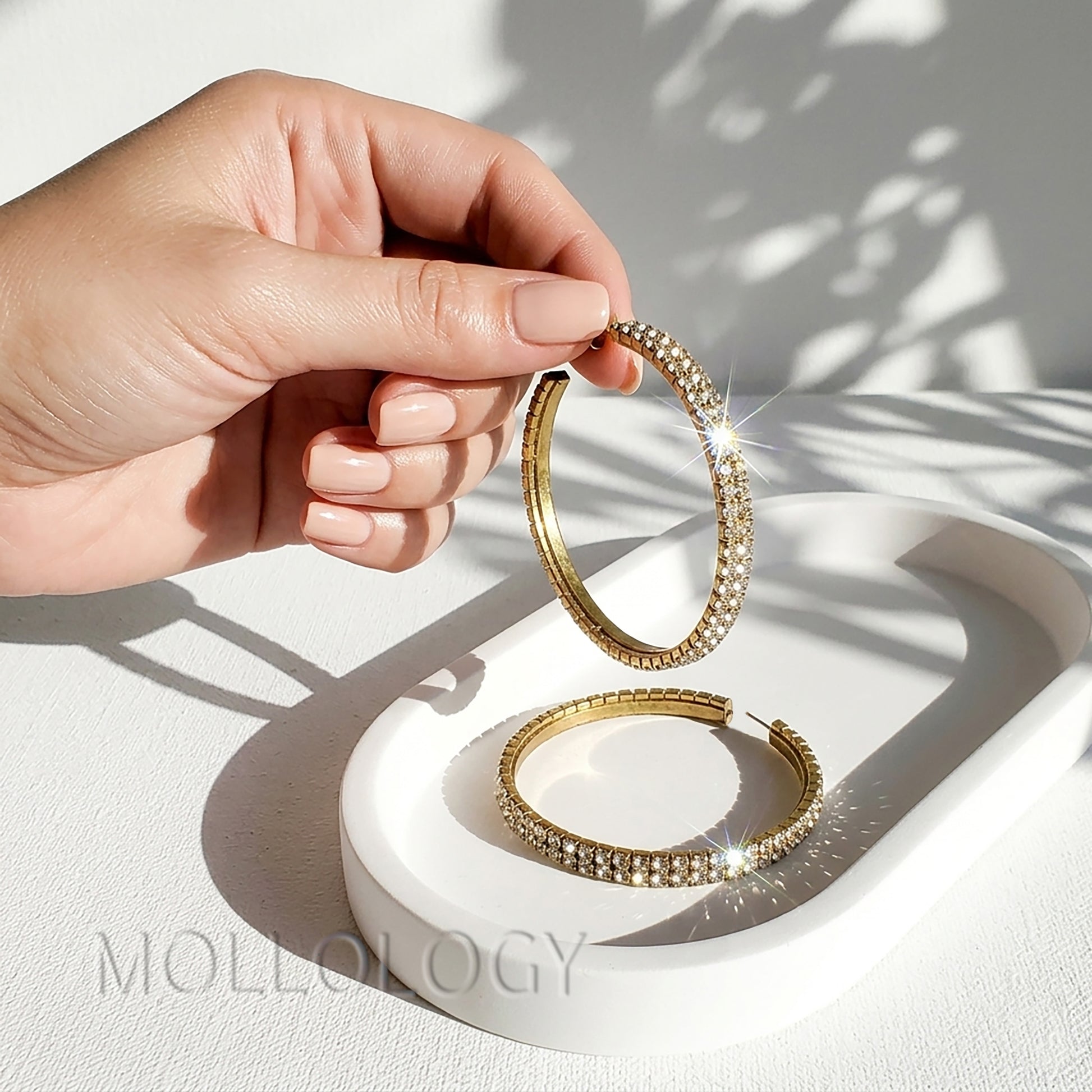 Large gold CZ hoop earrings shown on white background, elegant sparkly statement jewelry product photo by MOLLOLOGY.