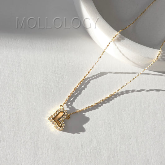 Gold pave heart pendant necklace on white tray, sparkling minimalist CZ heart jewelry product photo by MOLLOLOGY.
