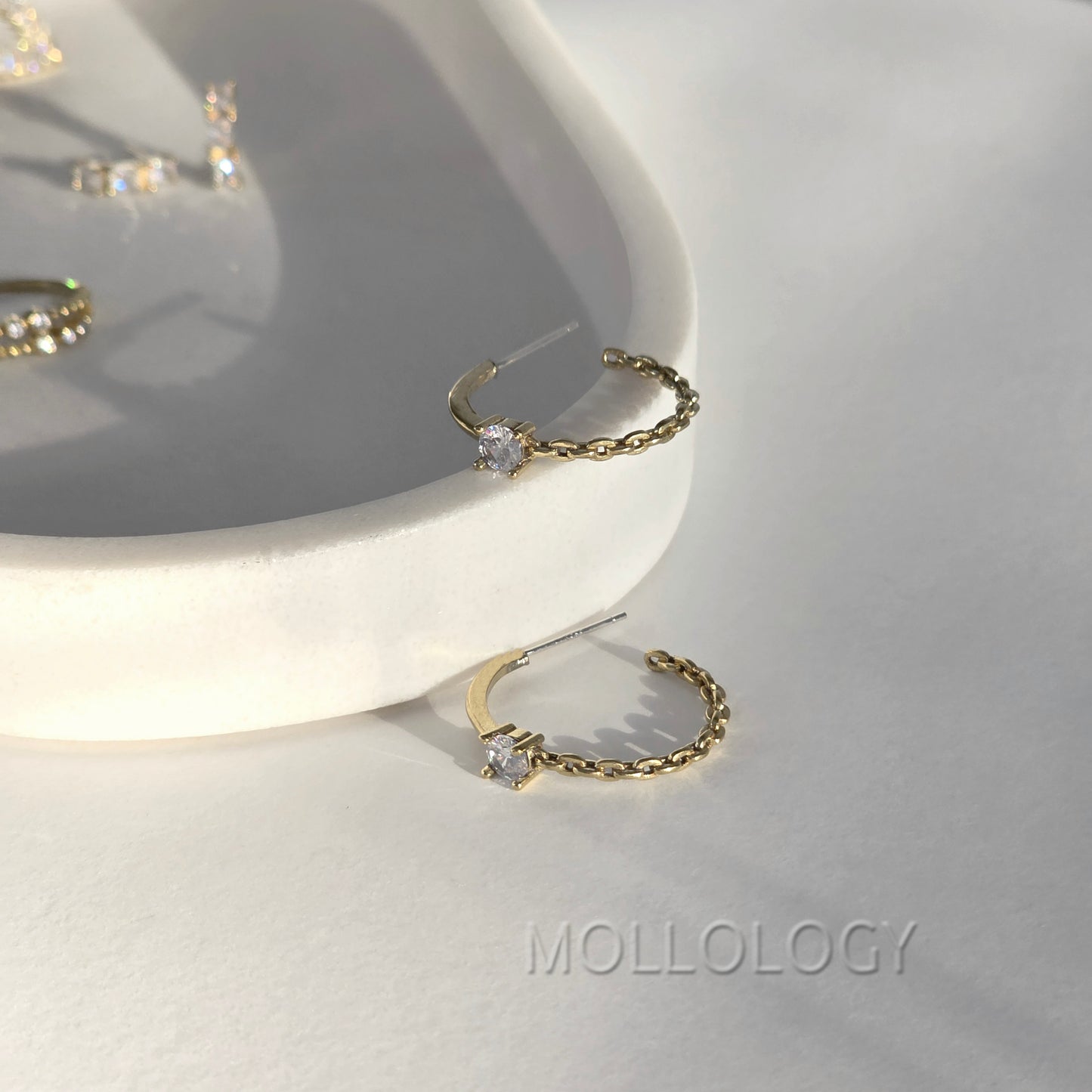 Dainty gold chain hoop earrings with CZ stone on white tray, minimalist MOLLOLOGY jewelry product photo.