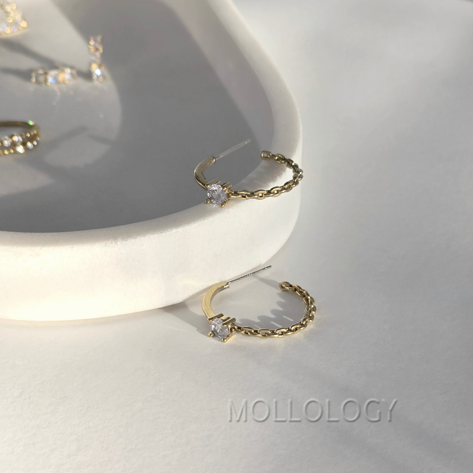 Dainty gold chain hoop earrings with CZ stone on white tray, minimalist MOLLOLOGY jewelry product photo.