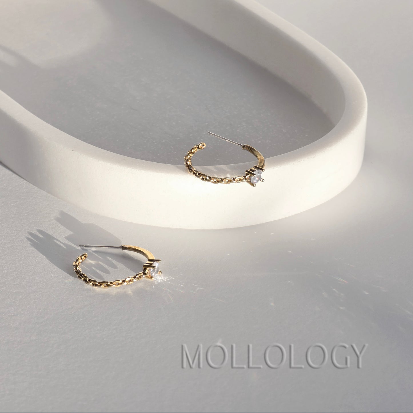Dainty gold chain hoop earrings with CZ stone on white tray, minimalist MOLLOLOGY jewelry product photo.