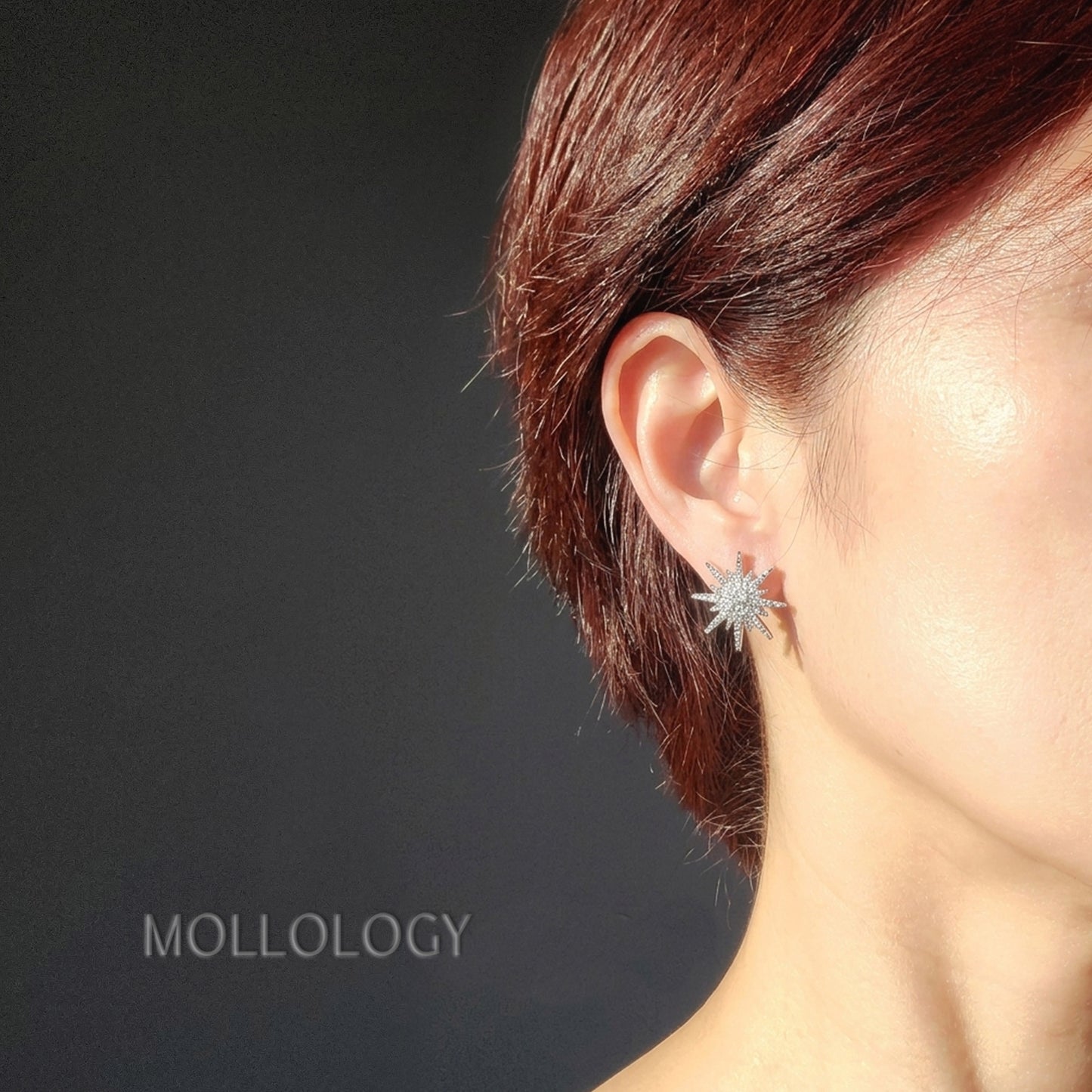 dainty silver starburst stud earrings on a model, great for everyday wear