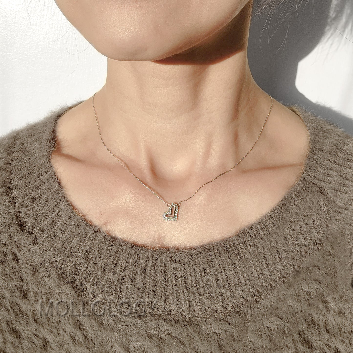 Dainty silver heart necklace with pave CZ stones on model, minimalist everyday love pendant by MOLLOLOGY.