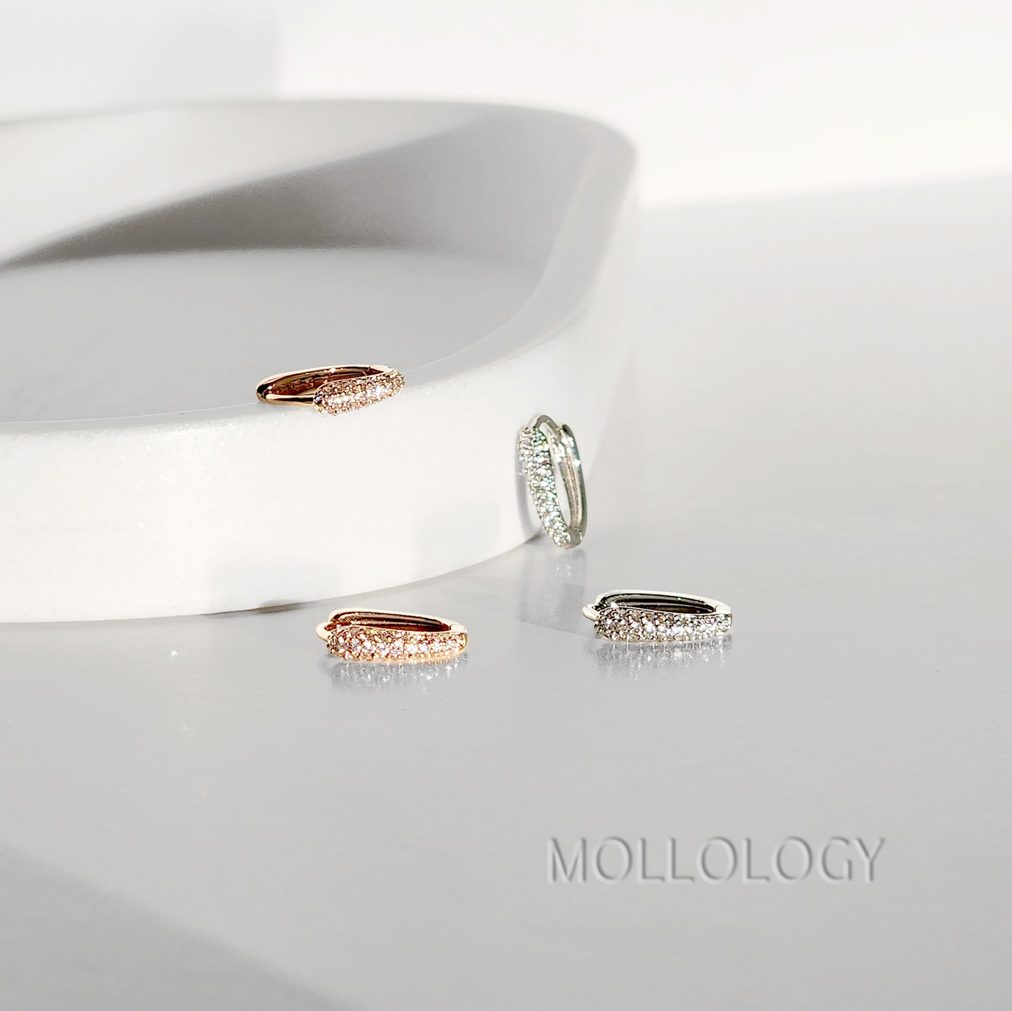 Delicate rose gold huggie hoop earrings with sparkling pavé cubic zirconia. Minimalist, dainty, and lightweight—perfect small hoops for everyday wear, cartilage piercings, or stacking. Timeless thin hoop earrings in rose gold or white gold.