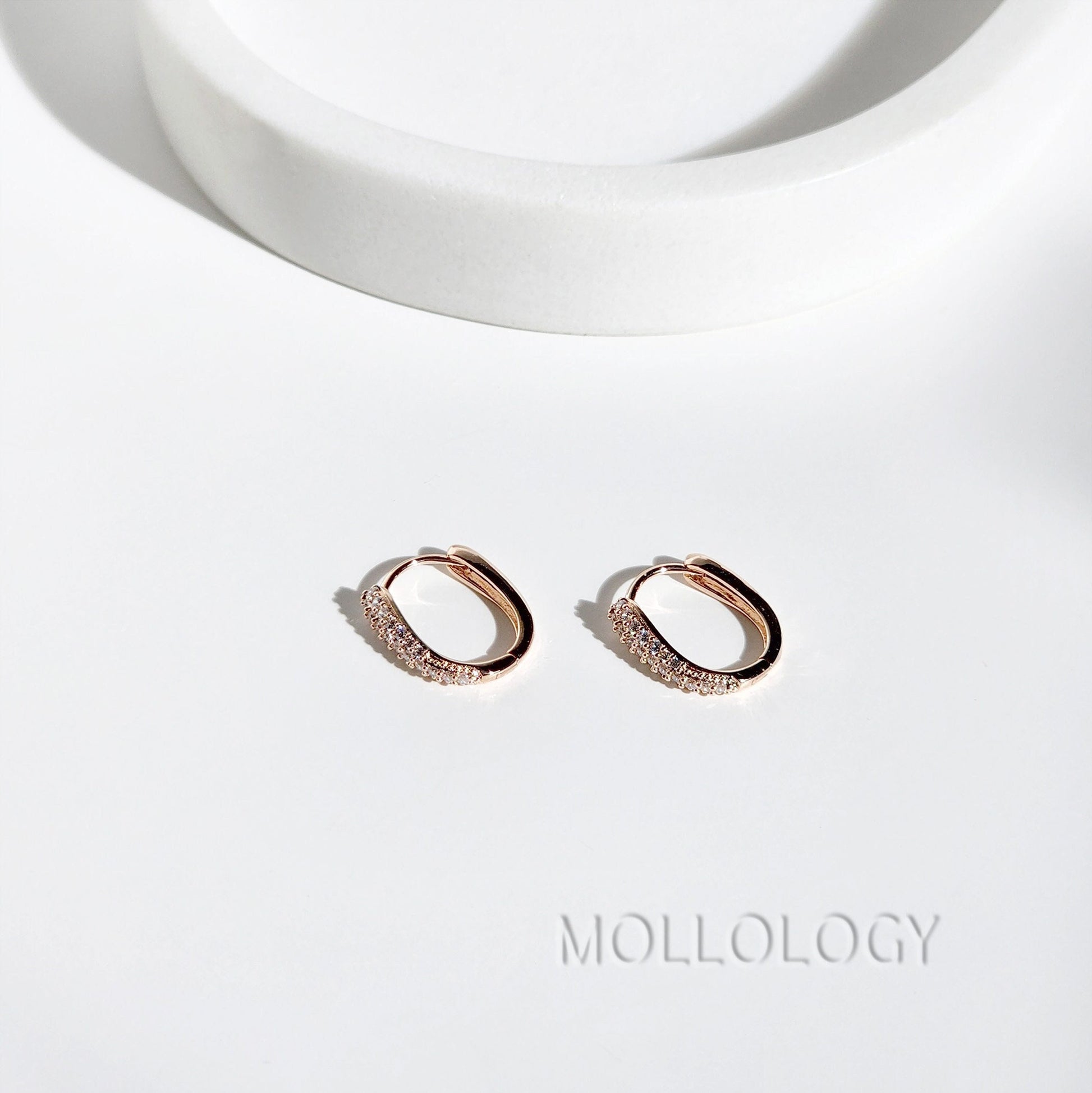 Delicate rose gold huggie hoop earrings with sparkling pavé cubic zirconia. Minimalist, dainty, and lightweight—perfect small hoops for everyday wear, cartilage piercings, or stacking. Timeless thin hoop earrings in rose gold or white gold.