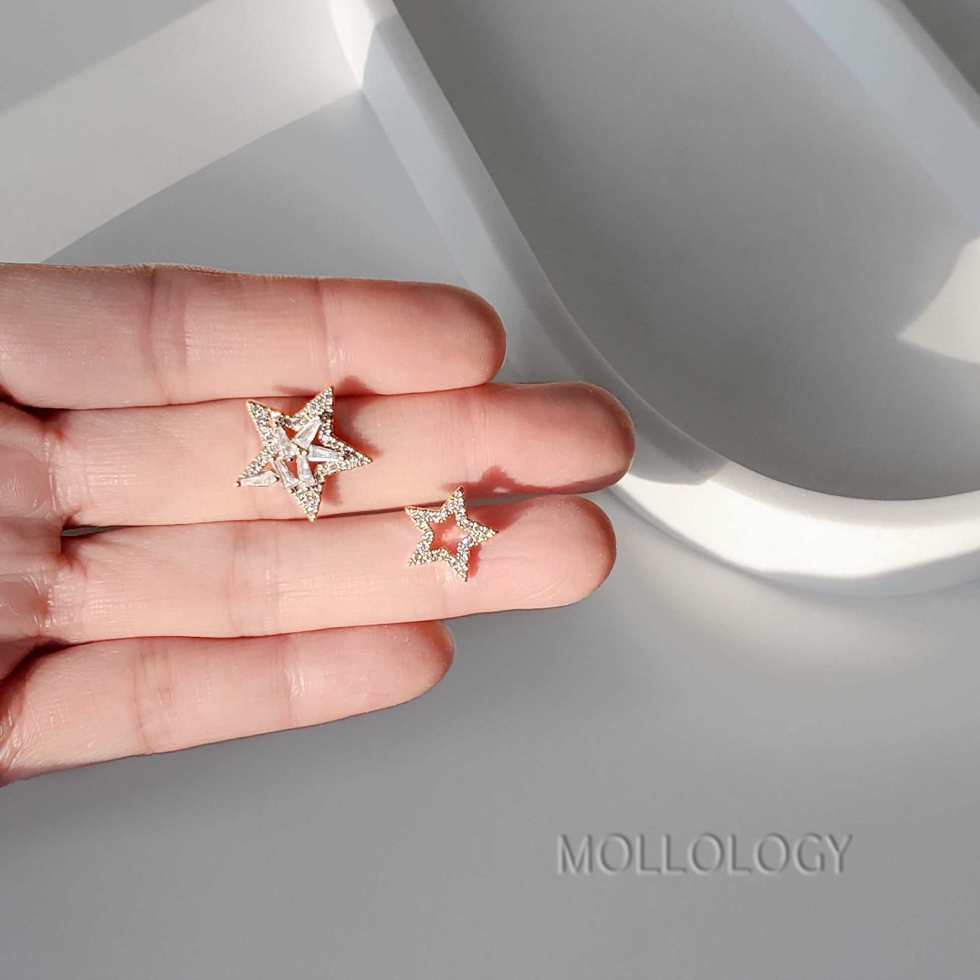 These dainty CZ star earrings feature a chic open star design with baguette details in shiny silver, creating modern celestial earrings that catch the light beautifully. Ideal as everyday star stud earrings or special-occasion jewelry, they are lightweight, comfortable, and perfect for stacking with other dainty silver earrings. Lovely as bridal and bridesmaids earrings, these star earrings make a thoughtful gift for her for birthdays, holidays, or weddings.