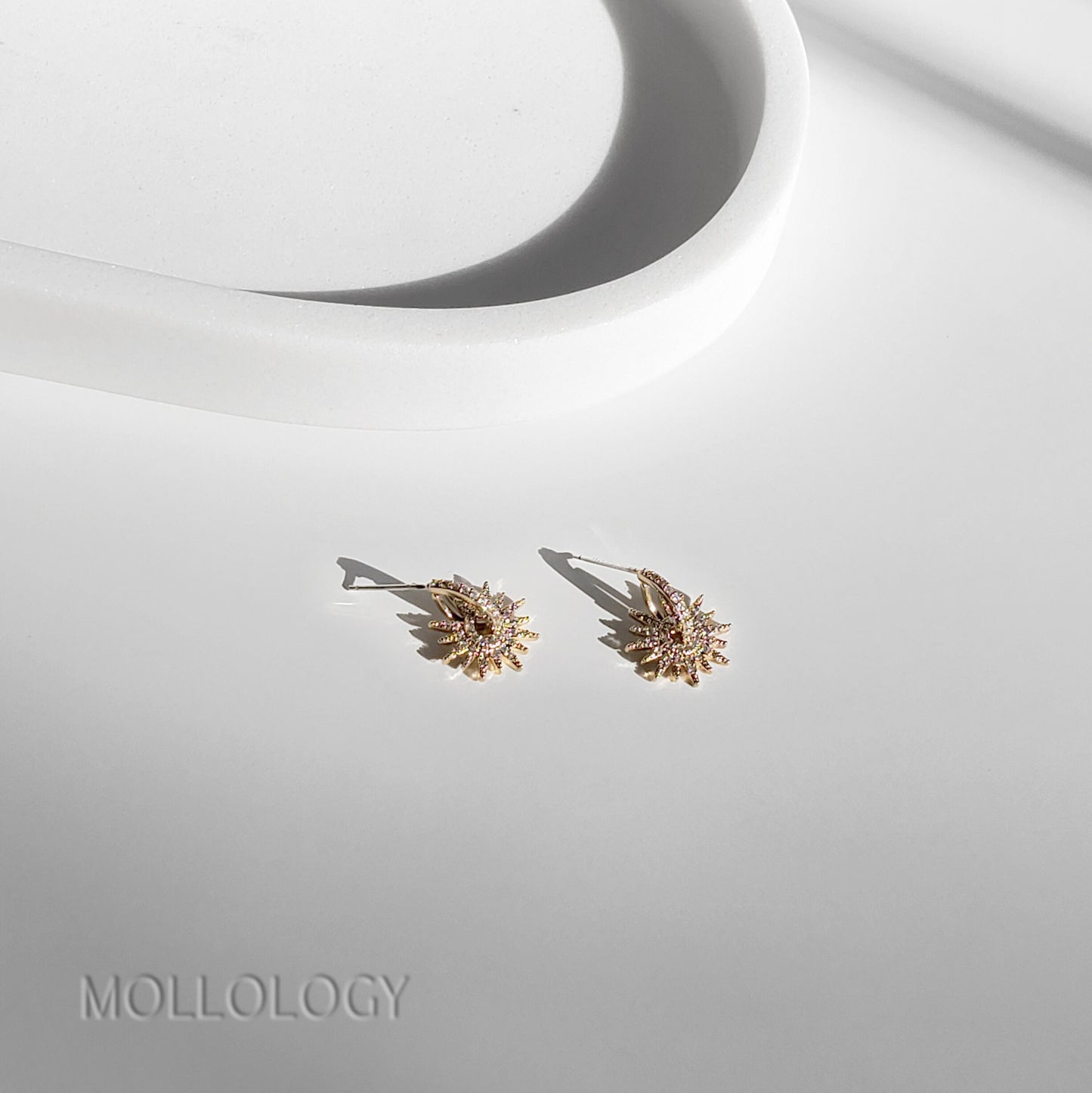 Gold starburst earrings with pavé CZ stones, Art Deco-inspired design, dainty bridal and wedding studs, perfect for bridesmaids or elegant everyday wear.