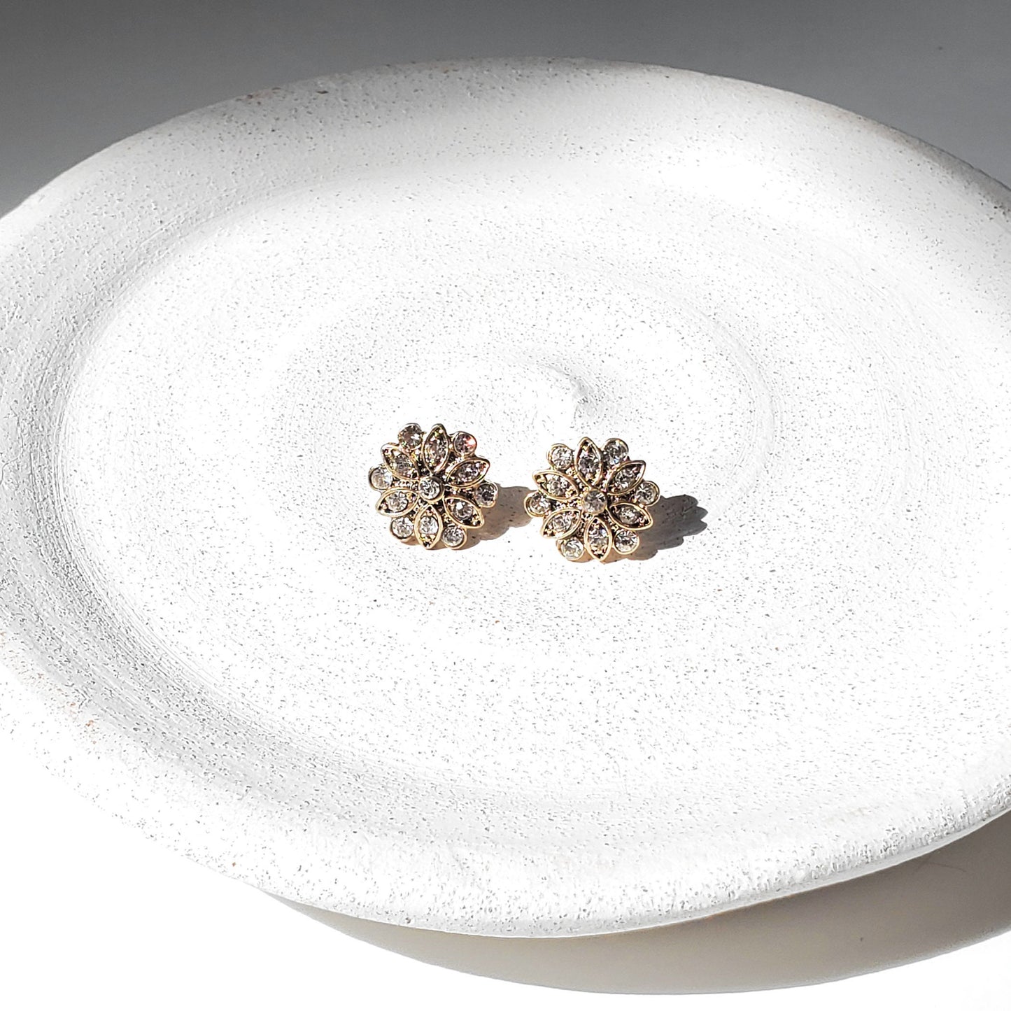 Dainty antique gold flower earrings with sparkling CZ stones in a mid-century, atomic sunburst design. Vintage-inspired floral studs perfect for brides, bridesmaids, weddings, special occasions, or elegant everyday wear. Timeless gold studs make a beautiful gift for her.