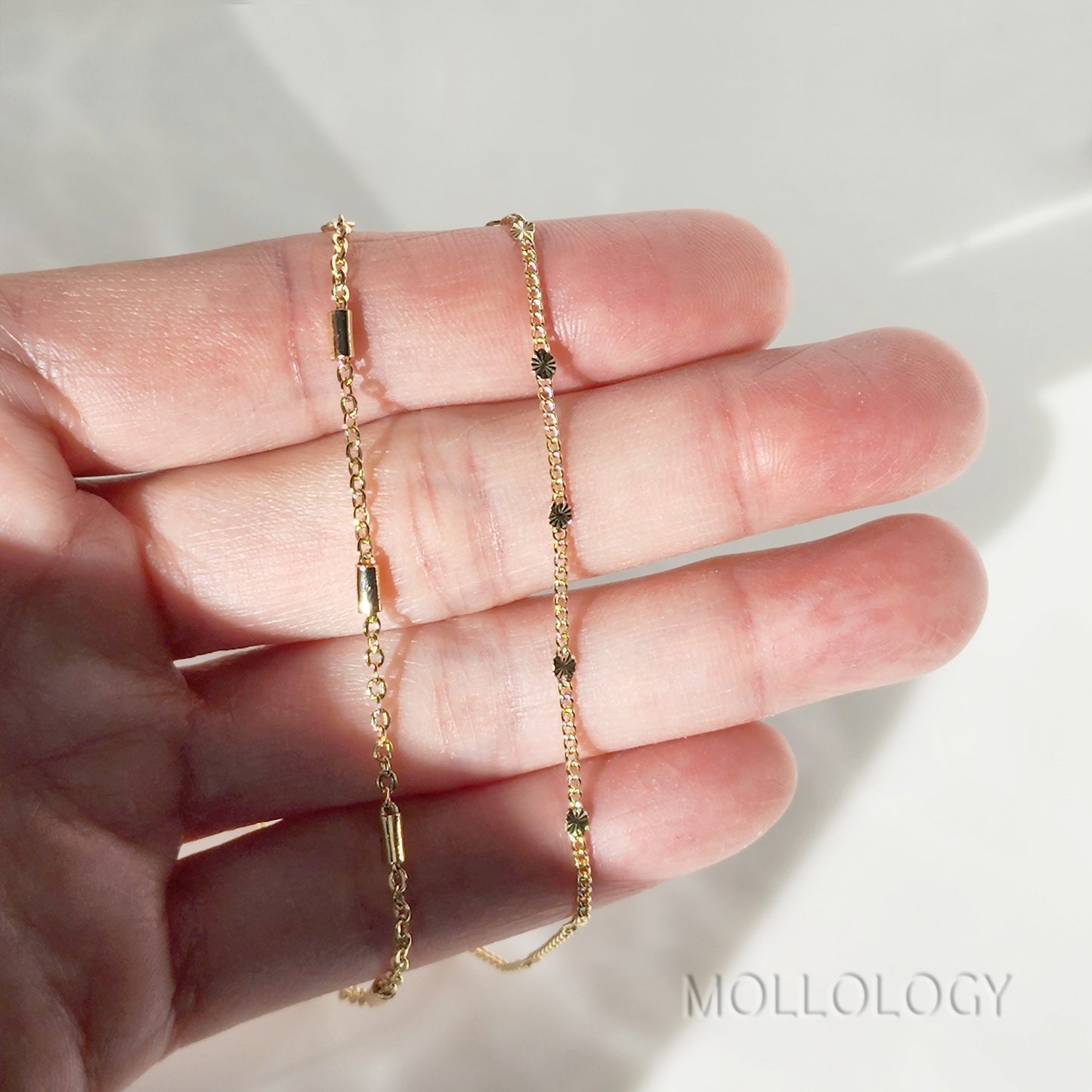 Minimalist gold bar bracelet featuring a thin polished horizontal bar integrated into a dainty gold link chain