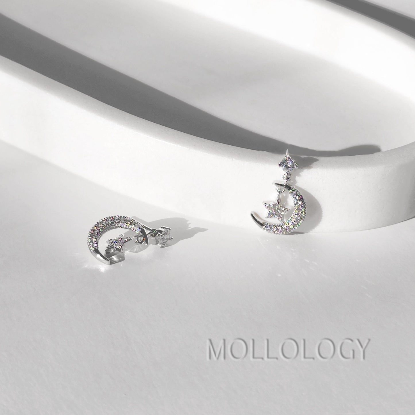 Close-up star stud earrings with CZ stone, dainty silver celestial jewelry detail shot MOLLOLOGY.