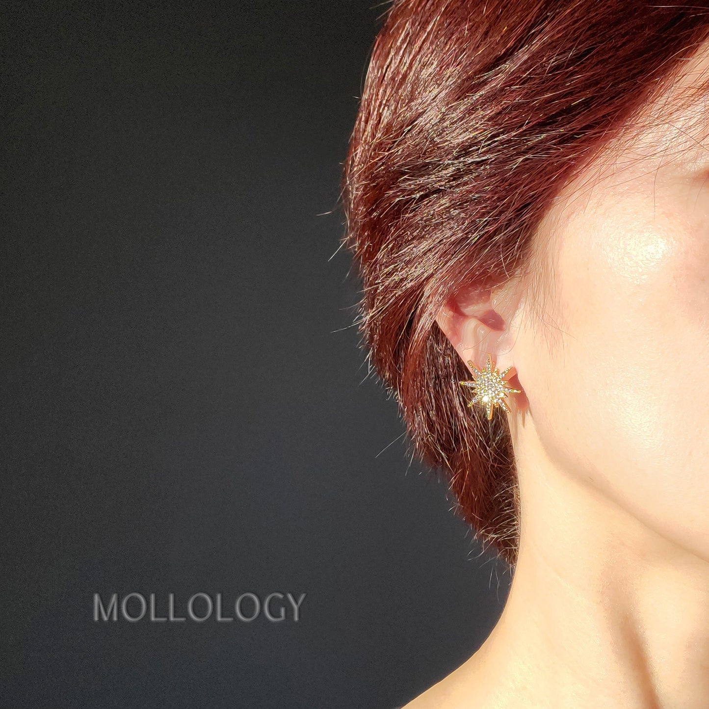 dainty gold starburst stud earrings on a model, great for everyday wear