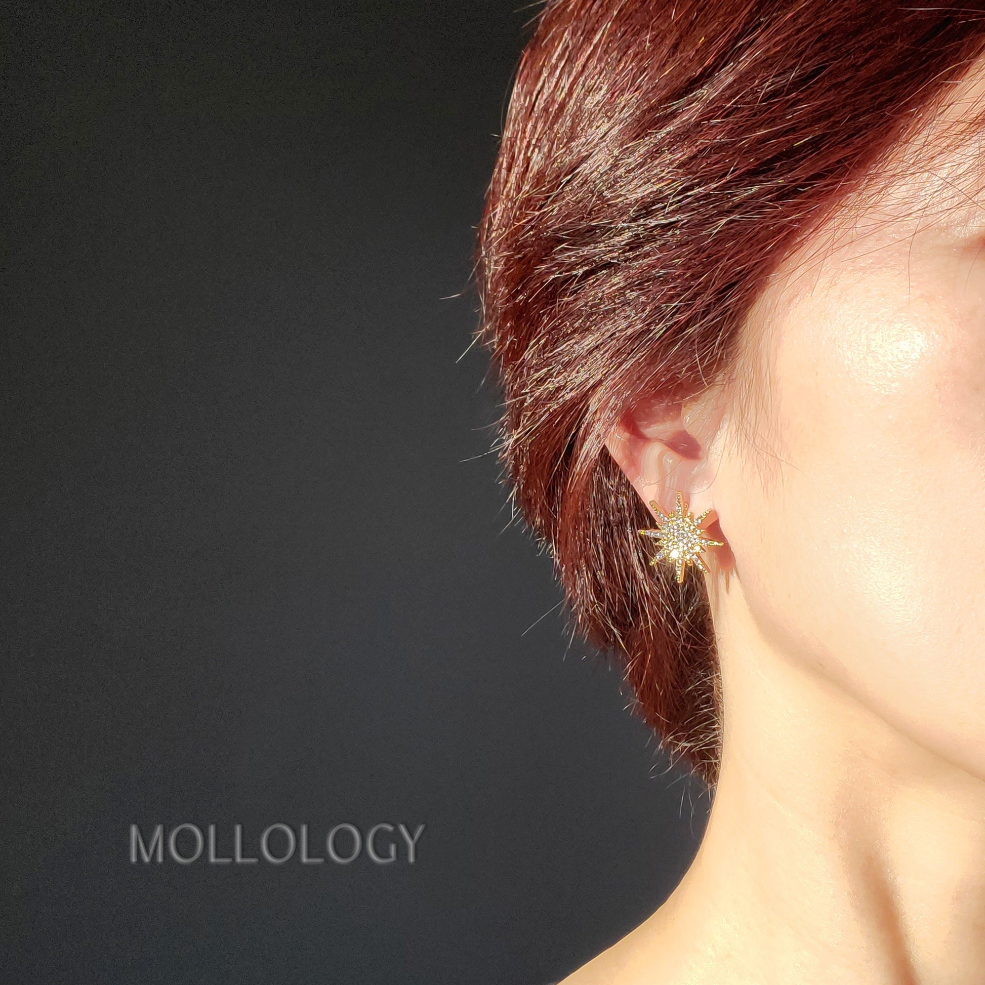 dainty gold starburst stud earrings on a model, great for everyday wear