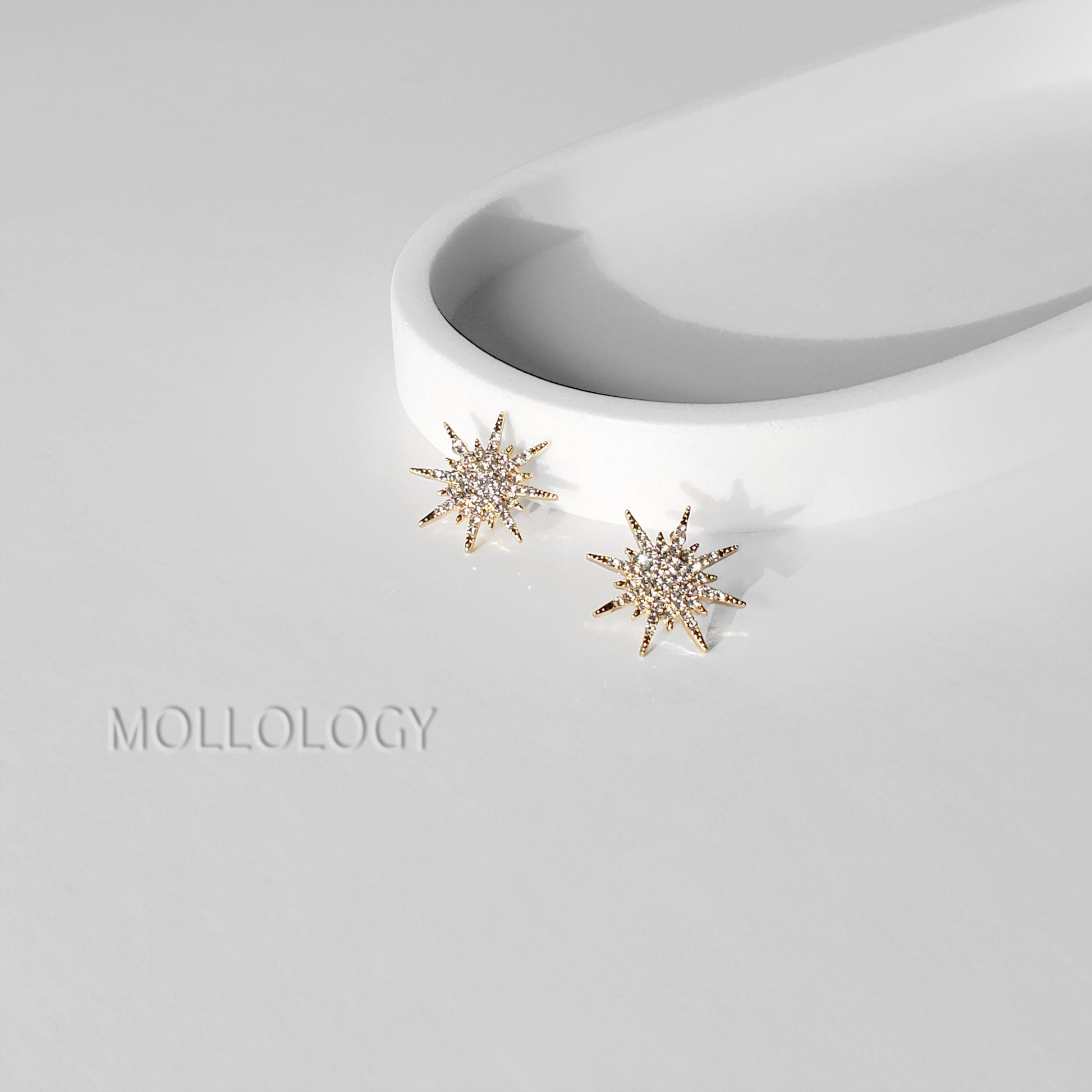 Dainty gold starburst earrings with sparkling CZ accents. Lightweight bridal and wedding jewelry, perfect for bridesmaids or elegant everyday wear.