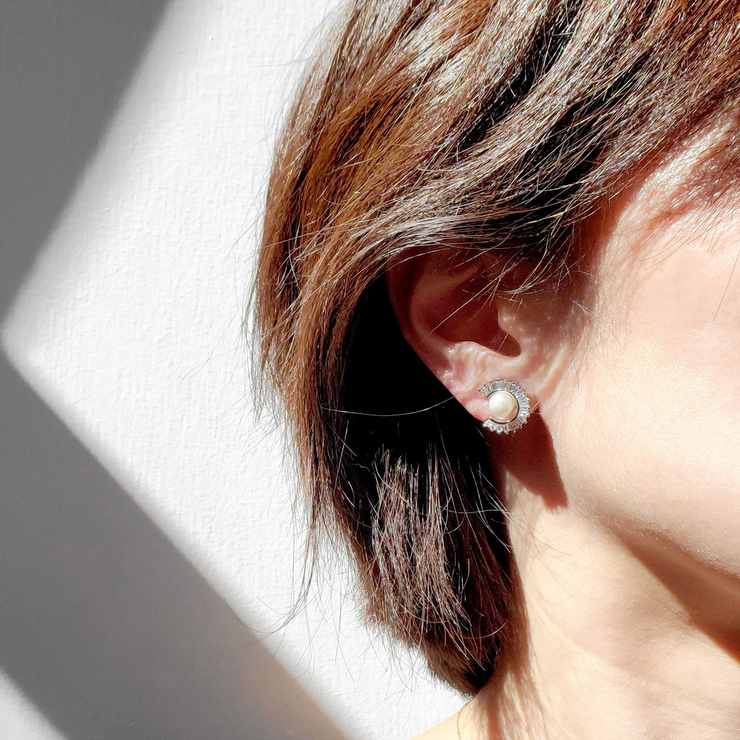 Freshwater Pearl Sunburst Stud Earrings blend modern sparkle with timeless elegance. Designed with a radiant baguette CZ sunburst framing a lustrous freshwater pearl, these studs bring a luxurious yet minimalist touch to any style perfect for everyday wear or special occasions.
